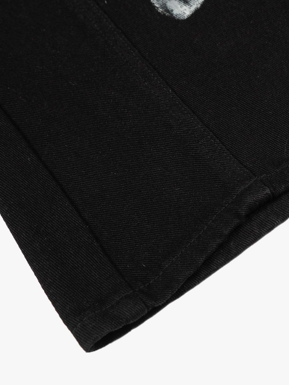 Close-up of Black Star Paint Baggy Jeans hem, showing twill weave, folded edge, and stitching, highlighting their oversized, artistic design and high-street aesthetic.