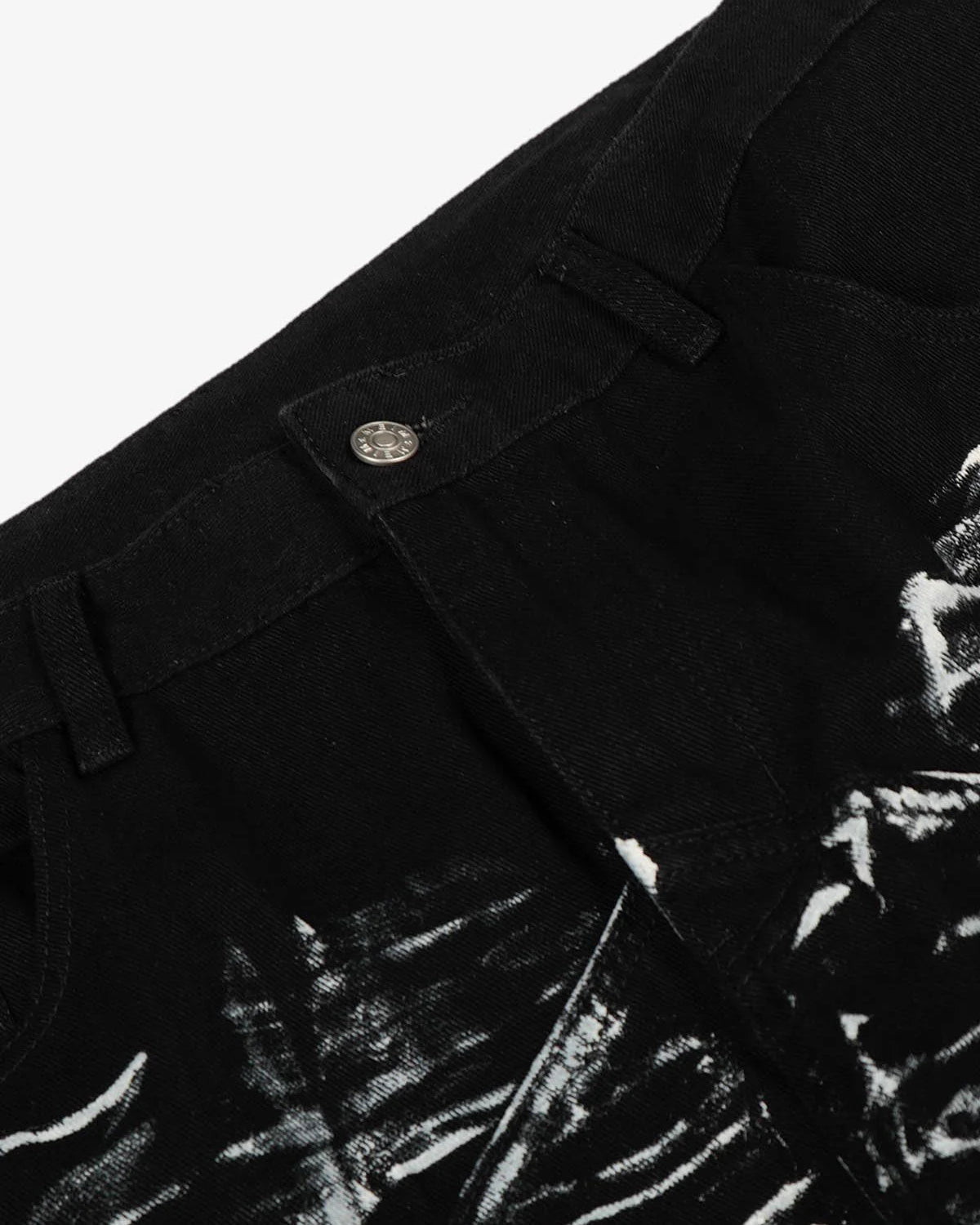 Black Star Paint Baggy Jeans close-up showing waistband, belt loops, and metal button, featuring white paint-splatter pattern and star graphics on black denim for a bold street style.