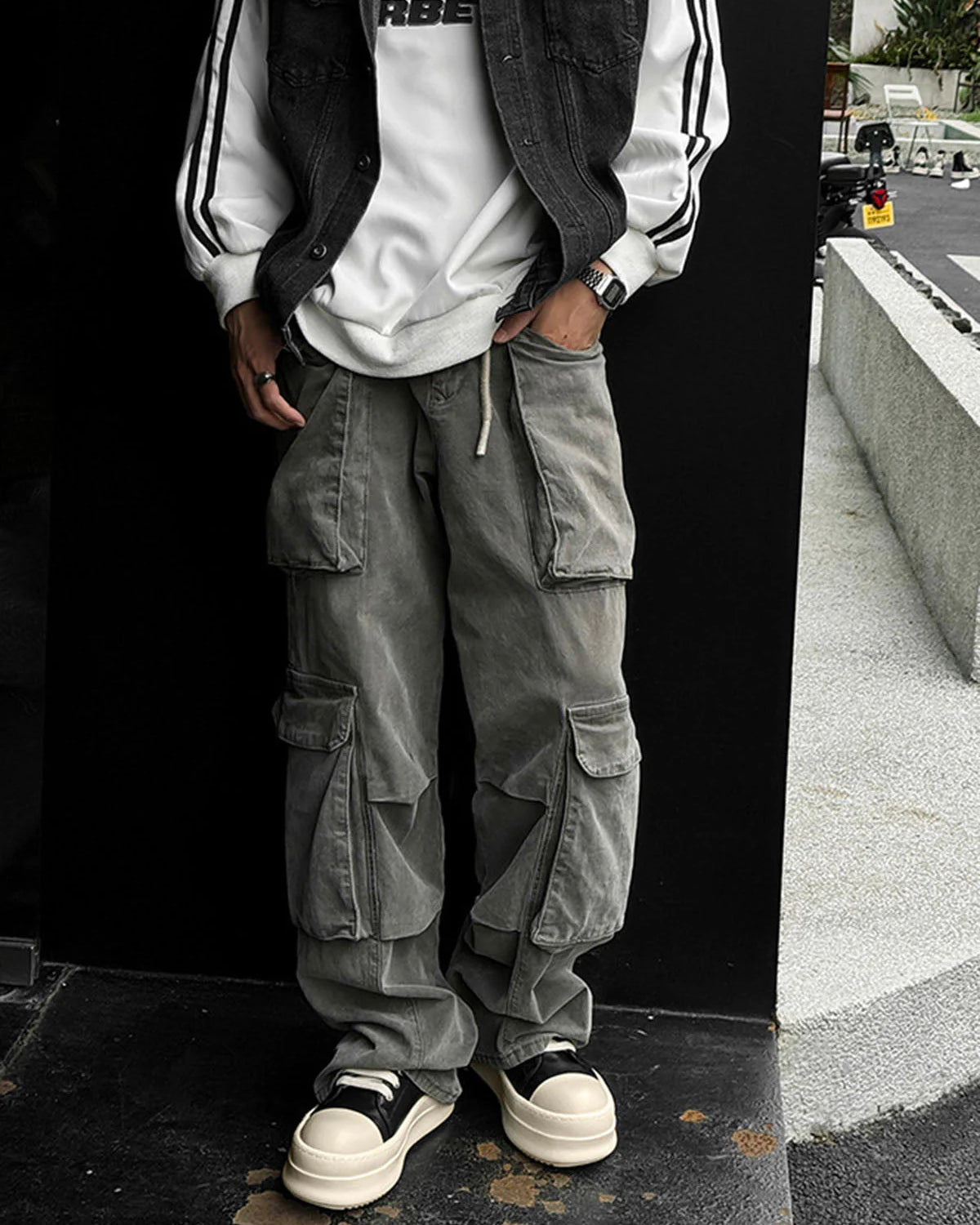 Chunky Low-Top Streetwear Sneakers with thick platform soles, black uppers, and off-white toe caps, styled with cargo pants for a modern urban look.