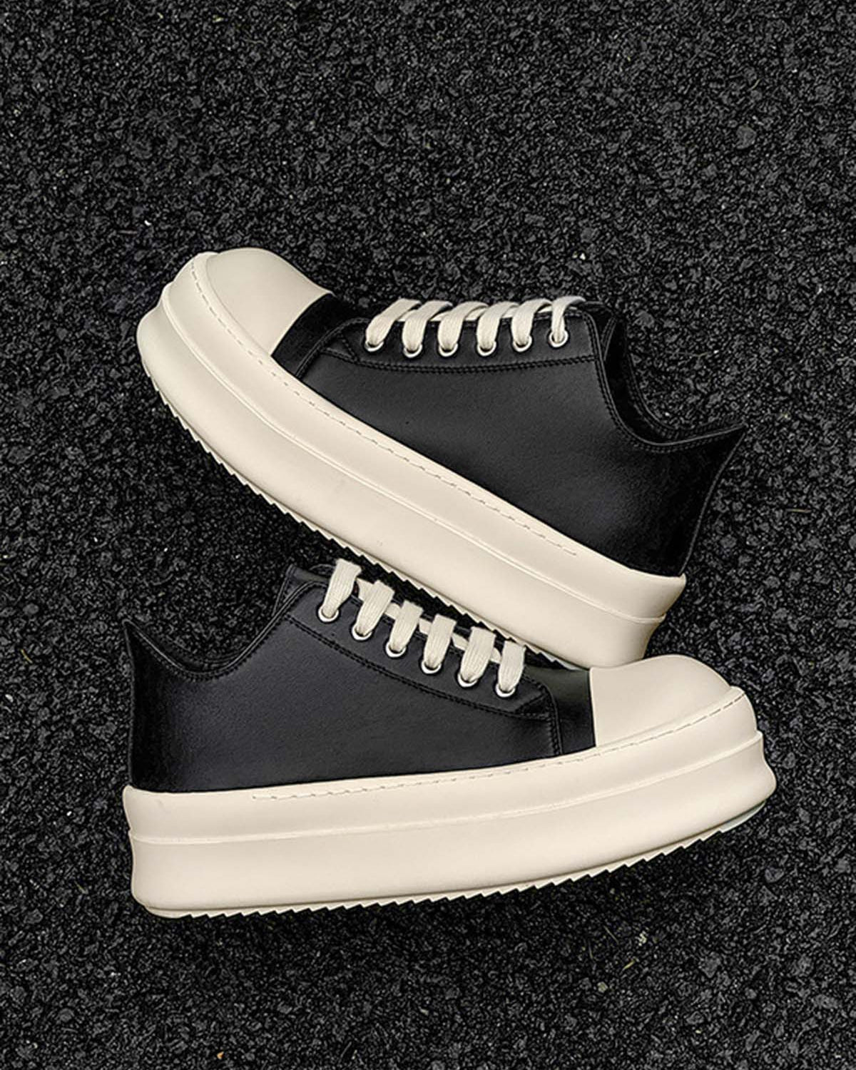 Chunky Low-Top Streetwear Sneakers with black leather uppers, off-white platform soles, and matching laces, offering a bold contrast and modern streetwear style.