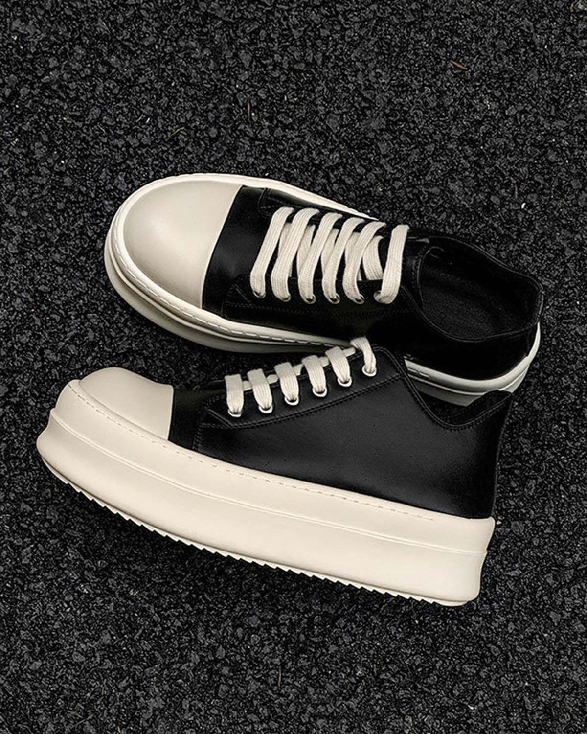 Chunky Low-Top Streetwear Sneakers with black leather uppers, white rubber toe caps, thick platform soles, and white laces, ideal for bold, modern street style.
