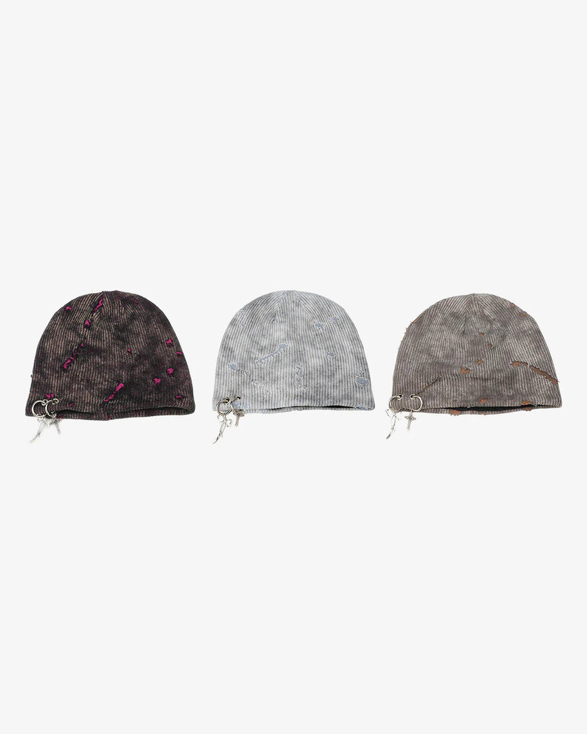 Three Distressed Charm Knit Hats with washed textures and metal charm details, showcasing dark, light gray, and dusty brown designs for grunge and streetwear styles.