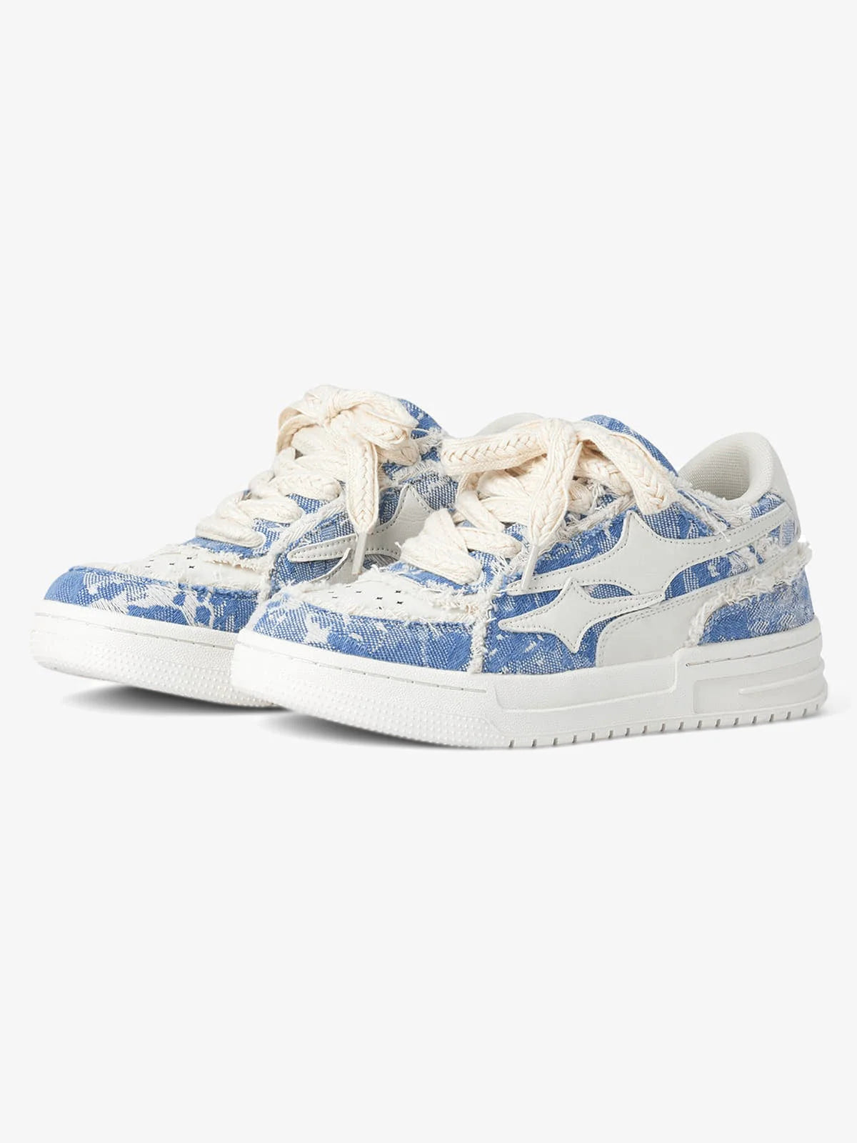 Distressed Denim Low-Top Street Sneakers with frayed blue-and-white denim uppers, thick white soles, cream laces, and a white leather logo appliqué on side panels.