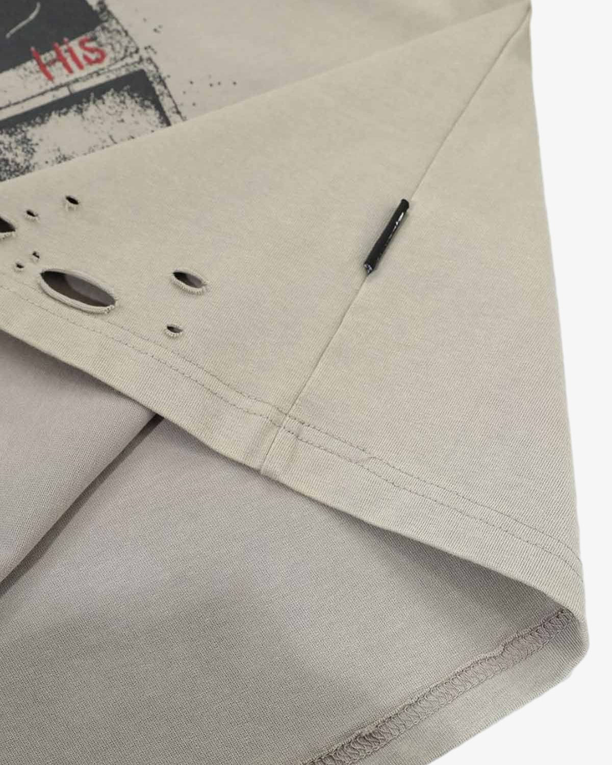 Distressed Grunge Layered T-Shirt with taupe cotton, red HIS graphic, black label, distressed holes, and camo long sleeves for a vintage, layered streetwear look.
