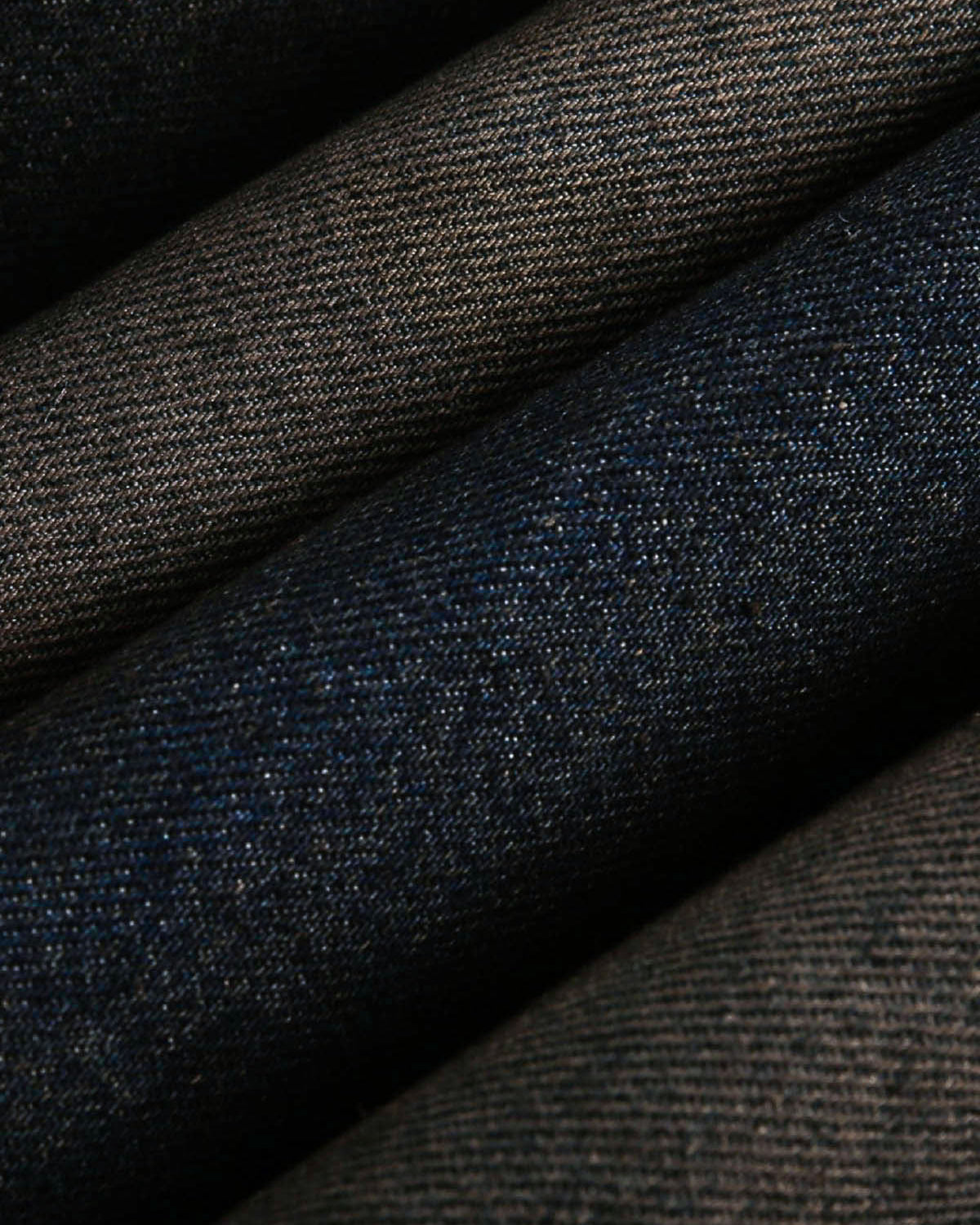 Close-up of folded denim, highlighting the rugged texture of the Distressed Washed Faux Fur Winter Jacket, showcasing its thick, warm design and faux-fur detailing.