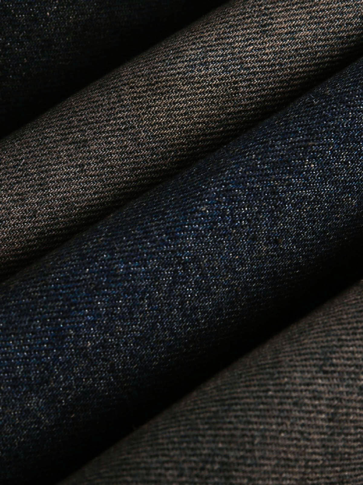Close-up of folded denim, highlighting the rugged texture of the Distressed Washed Faux Fur Winter Jacket, showcasing its thick, warm design and faux-fur detailing.