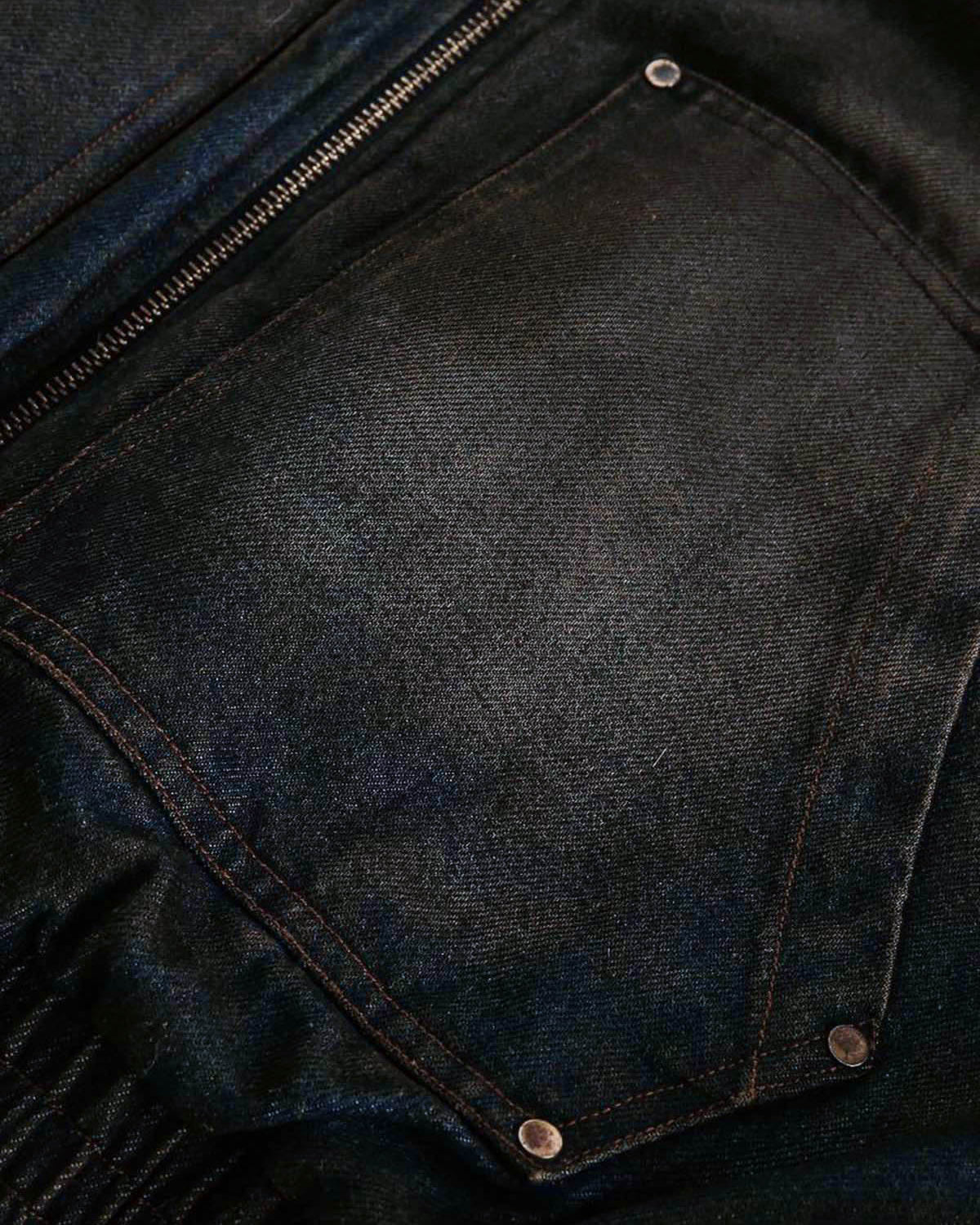 Close-up of Distressed Washed Faux Fur Winter Jacket, showing dark denim fabric with zipper seam and riveted pocket, highlighting rugged texture and practical design.