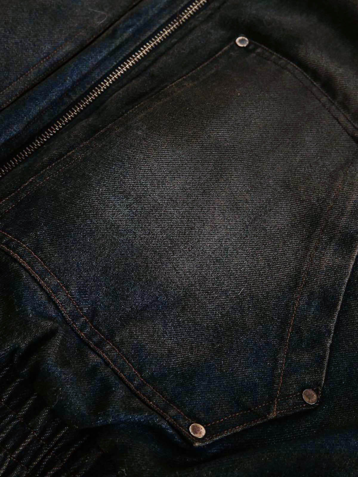 Close-up of Distressed Washed Faux Fur Winter Jacket, showing dark denim fabric with zipper seam and riveted pocket, highlighting rugged texture and practical design.