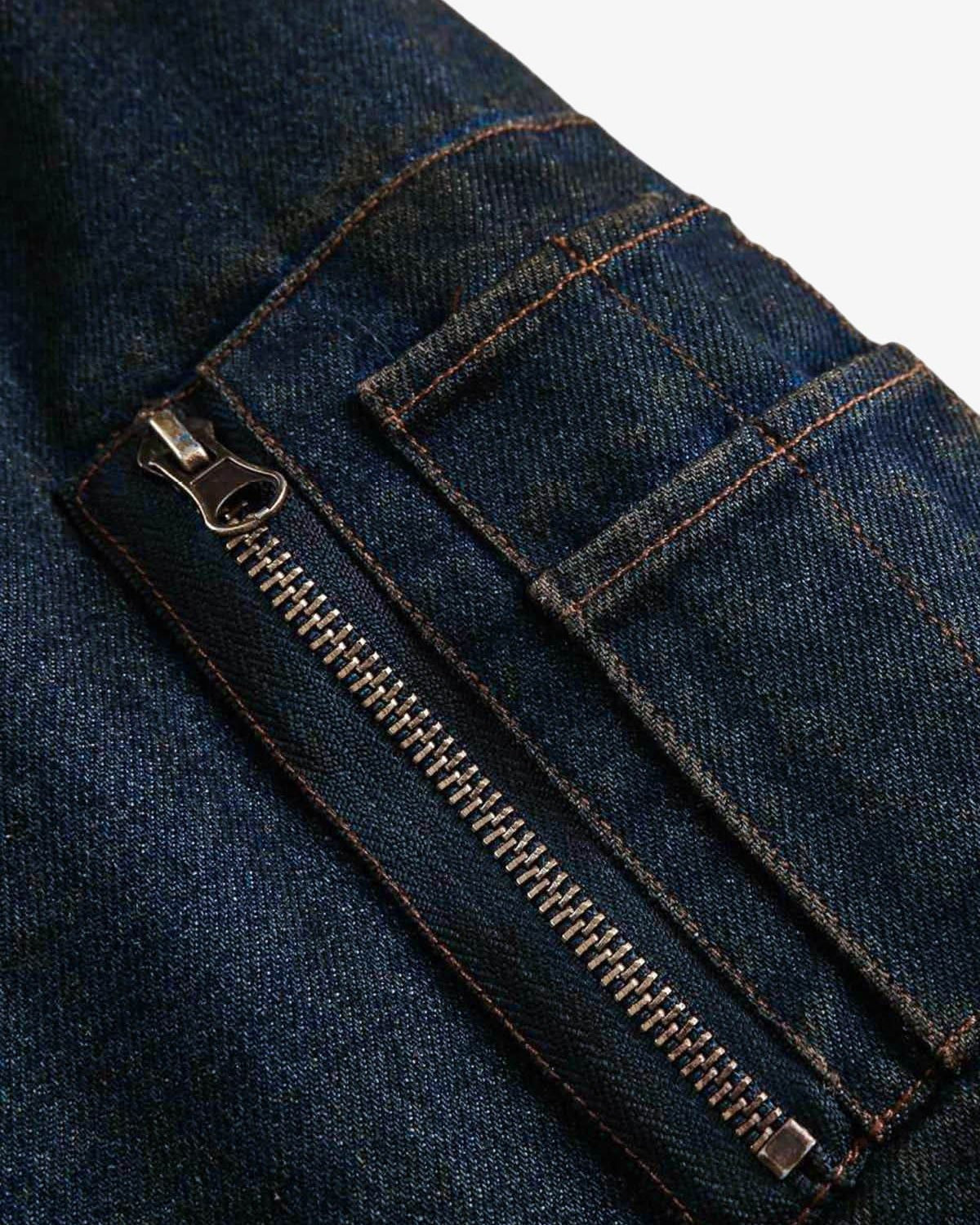 Close-up of Distressed Washed Faux Fur Winter Jacket, showing dark blue denim fabric with metal zipper and stitched pocket detail, highlighting its rugged texture.