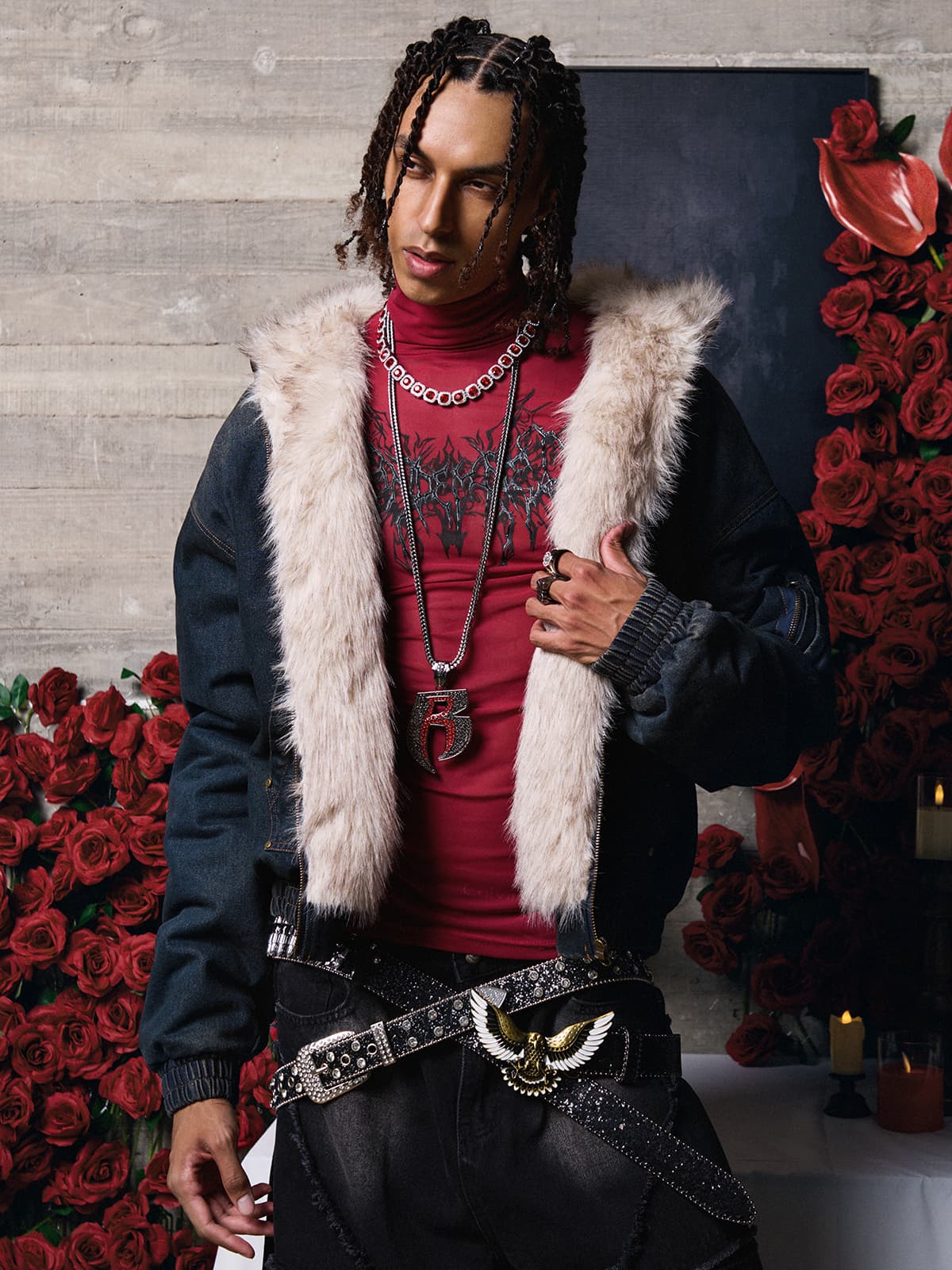 Model wearing Distressed Washed Faux Fur Winter Jacket with tan faux fur collar, layered over a red mock-neck top, complemented by layered chains and rings.