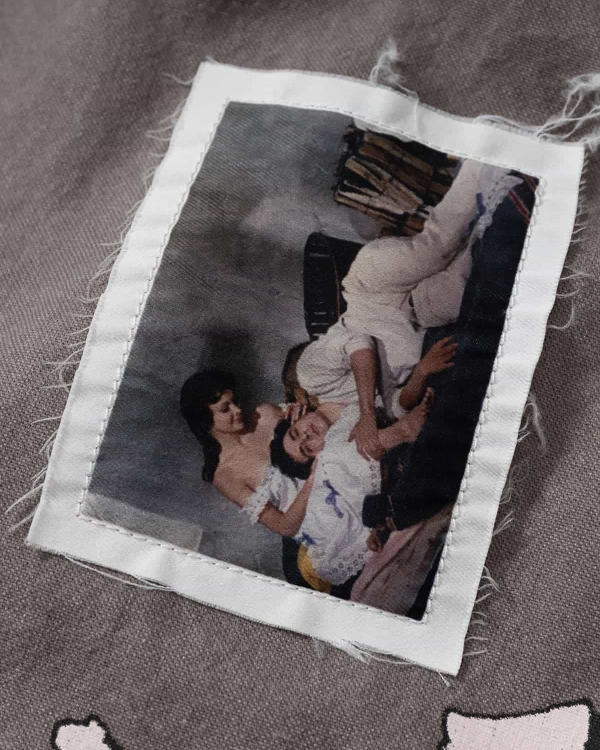 Graphic Graffiti High Neck Street Jacket featuring a vintage-style patch with a classical image, adding an edgy, distressed detail to the bold streetwear design.