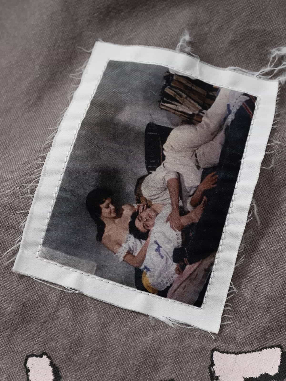 Graphic Graffiti High Neck Street Jacket featuring a vintage-style patch with a classical image, adding an edgy, distressed detail to the bold streetwear design.