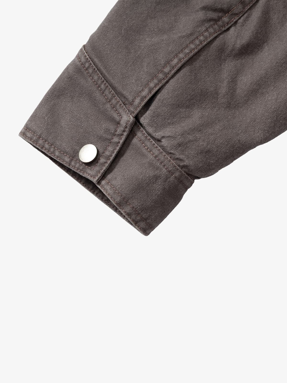 Close-up of Graphic Graffiti High Neck Street Jacket's grey canvas-style cuff with topstitching and silver snap button, highlighting its streetwear detail.