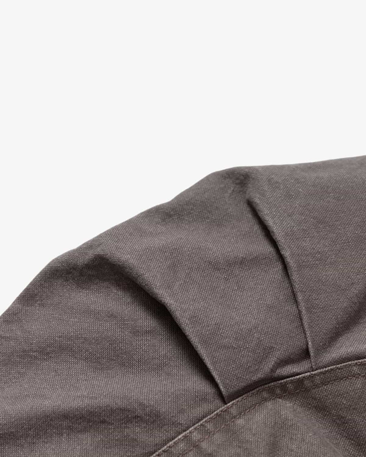 Close-up of the Graphic Graffiti High Neck Street Jacket, showcasing dark gray woven fabric with stitching and a pleat, highlighting its edgy streetwear style.