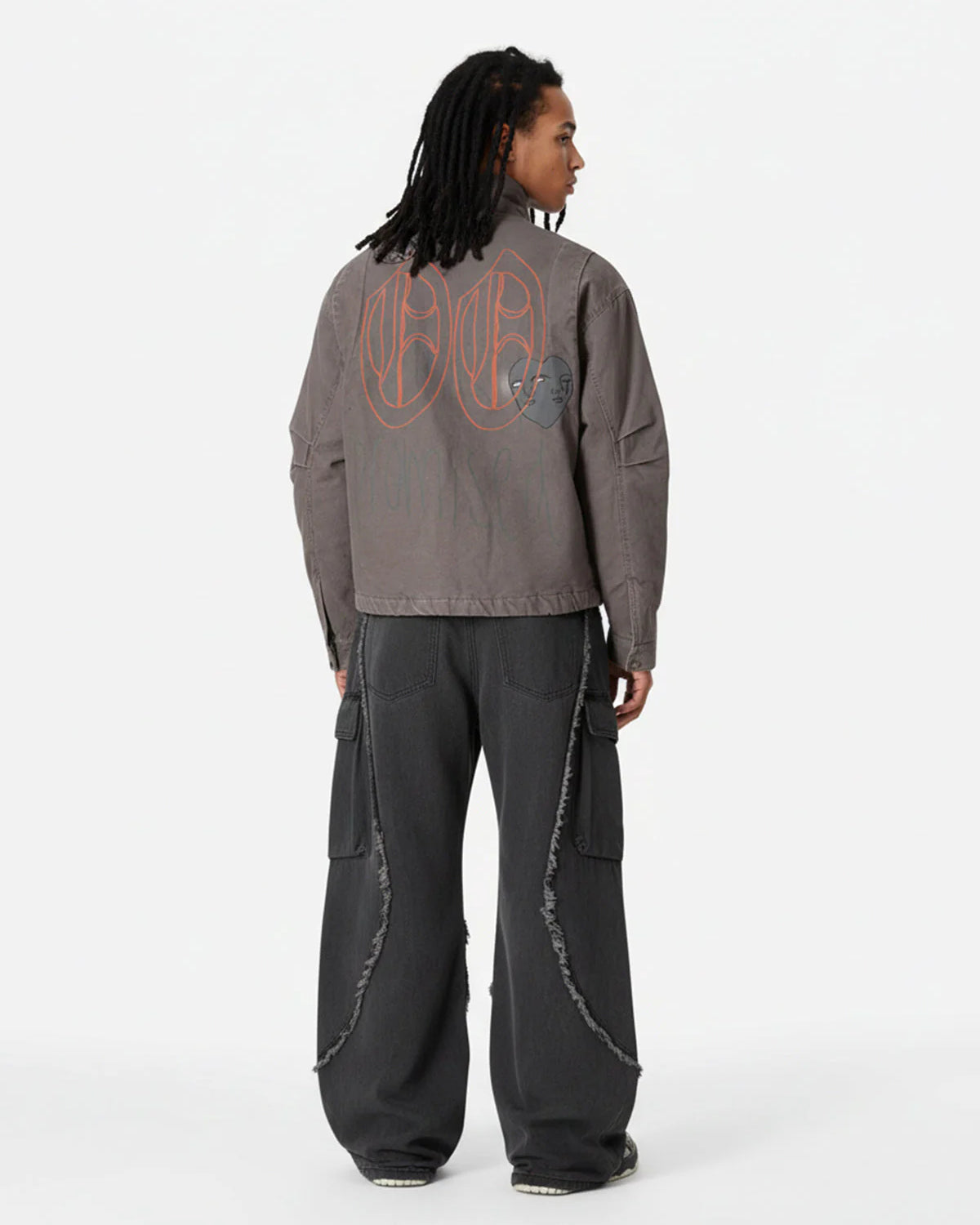 Graphic Graffiti High Neck Street Jacket features oversized line-art graphics, padded structure, and a high-neck silhouette, paired with loose-fitting charcoal-black cargo pants.