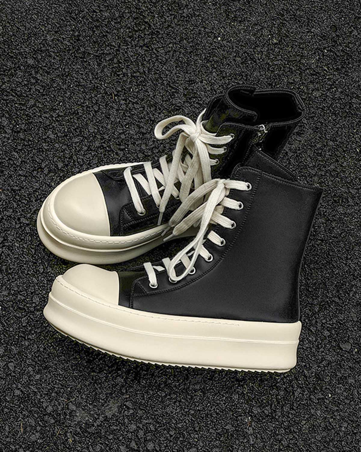 High-Top Platform Streetwear Sneakers with black uppers, oversized cream soles, and white laces, showcasing a bold silhouette for a modern streetwear look.
