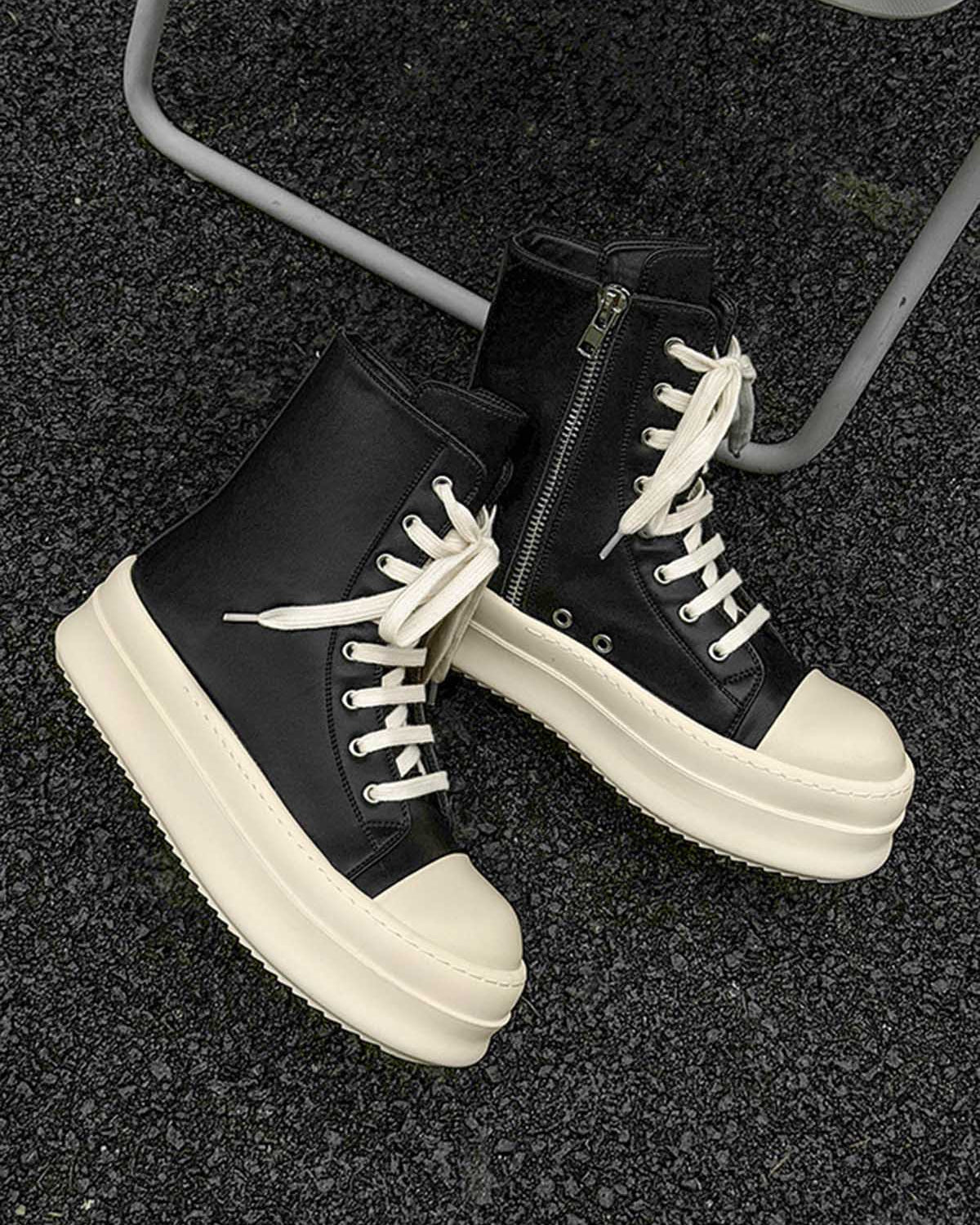 High-Top Platform Streetwear Sneakers featuring black high-top design with off-white chunky soles and laces, showcased on a rough asphalt surface for a bold, modern aesthetic.