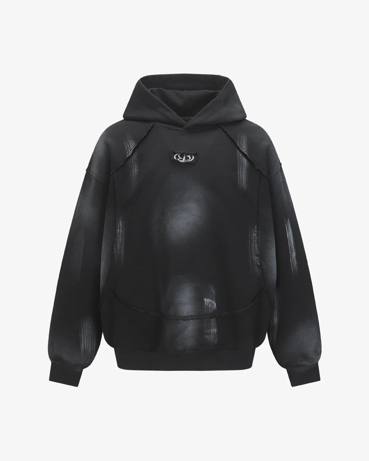 Ink Dyed Raw-Edge Streetwear Hoodie with a black oversized fit, dropped shoulders, kangaroo-style pouch, and a faded gray/white pattern, featuring a small chest emblem.