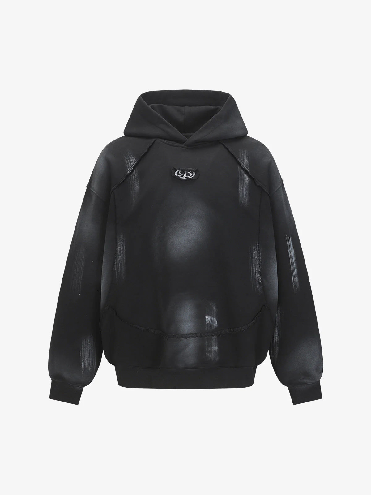 Ink Dyed Raw-Edge Streetwear Hoodie with a black oversized fit, dropped shoulders, kangaroo-style pouch, and a faded gray/white pattern, featuring a small chest emblem.