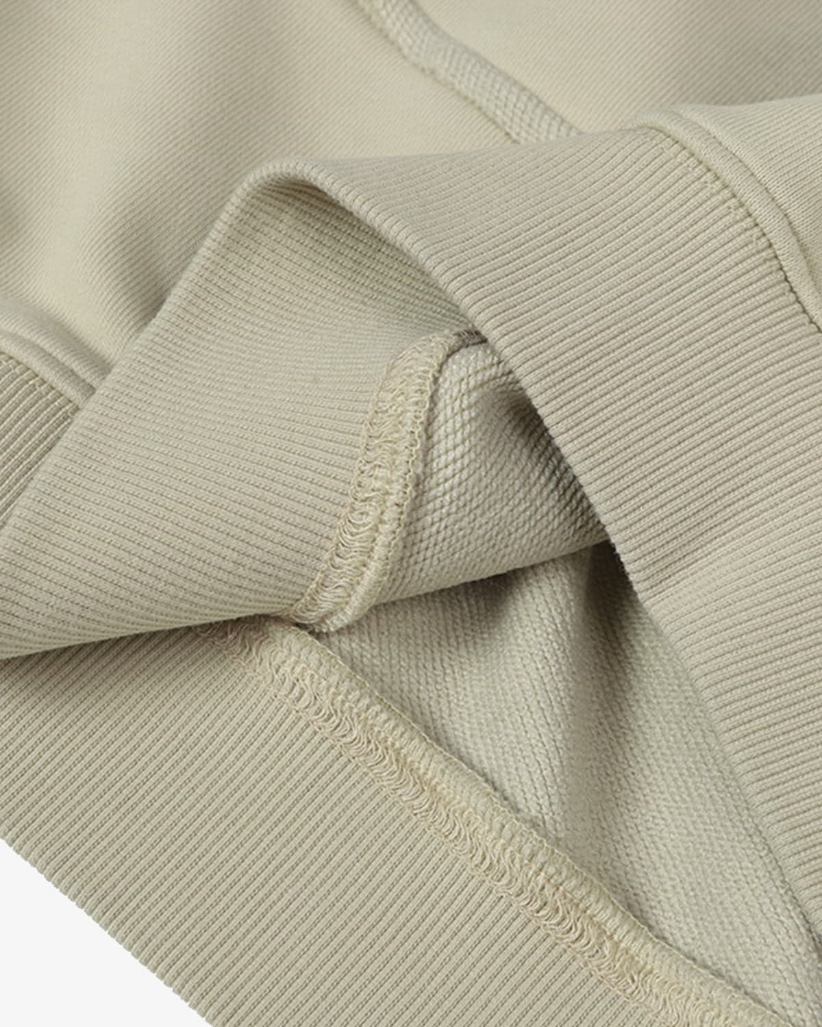 Close-up of the Ink Dyed Raw-Edge Streetwear Hoodie's ribbed knit cuff, showcasing overlock stitching and raw-edge detailing for an authentic streetwear vibe.