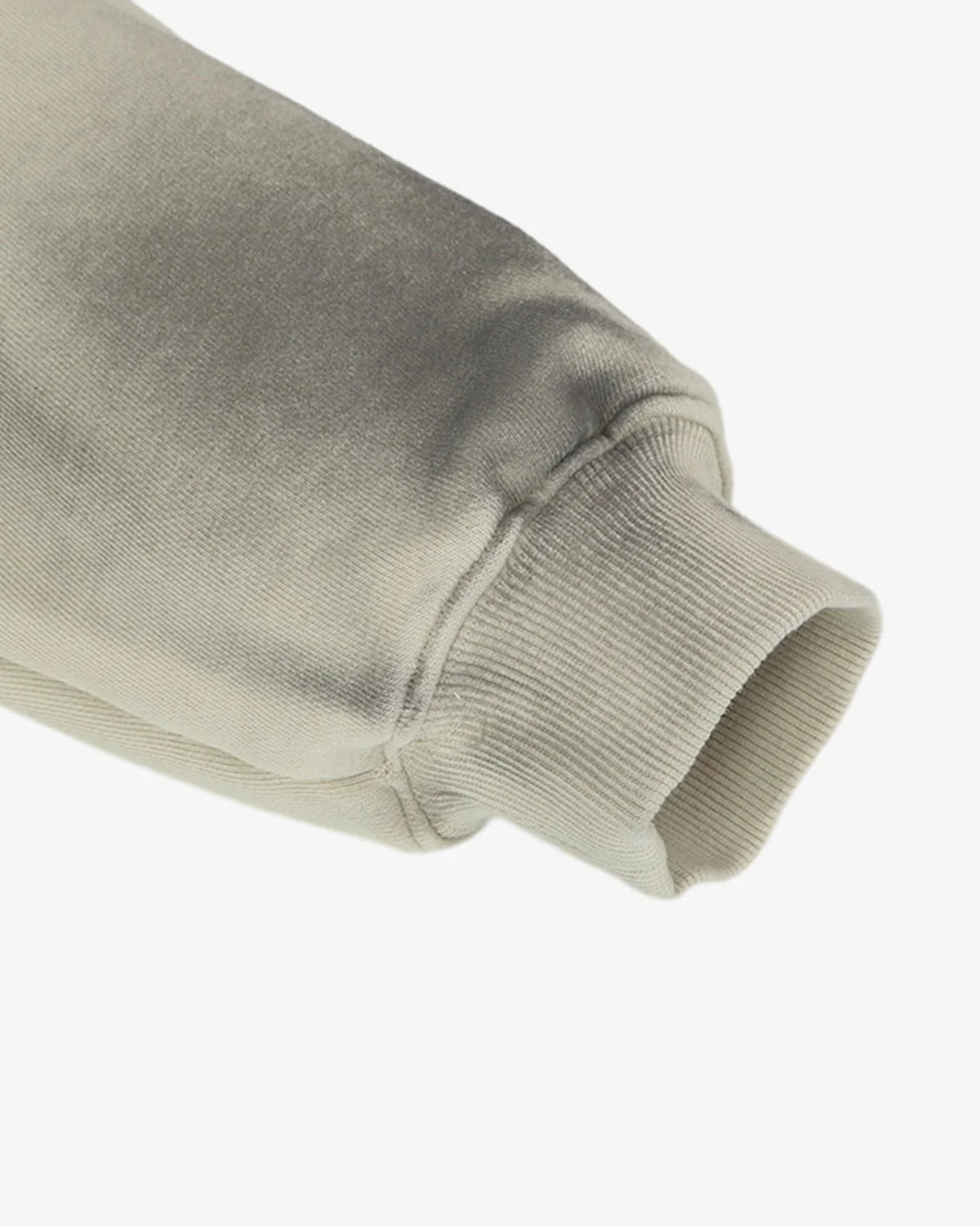 Close-up of the Ink Dyed Raw-Edge Streetwear Hoodie's sleeve, showcasing the ribbed cuff and ink-dyed fading for a bold, oversized streetwear aesthetic.
