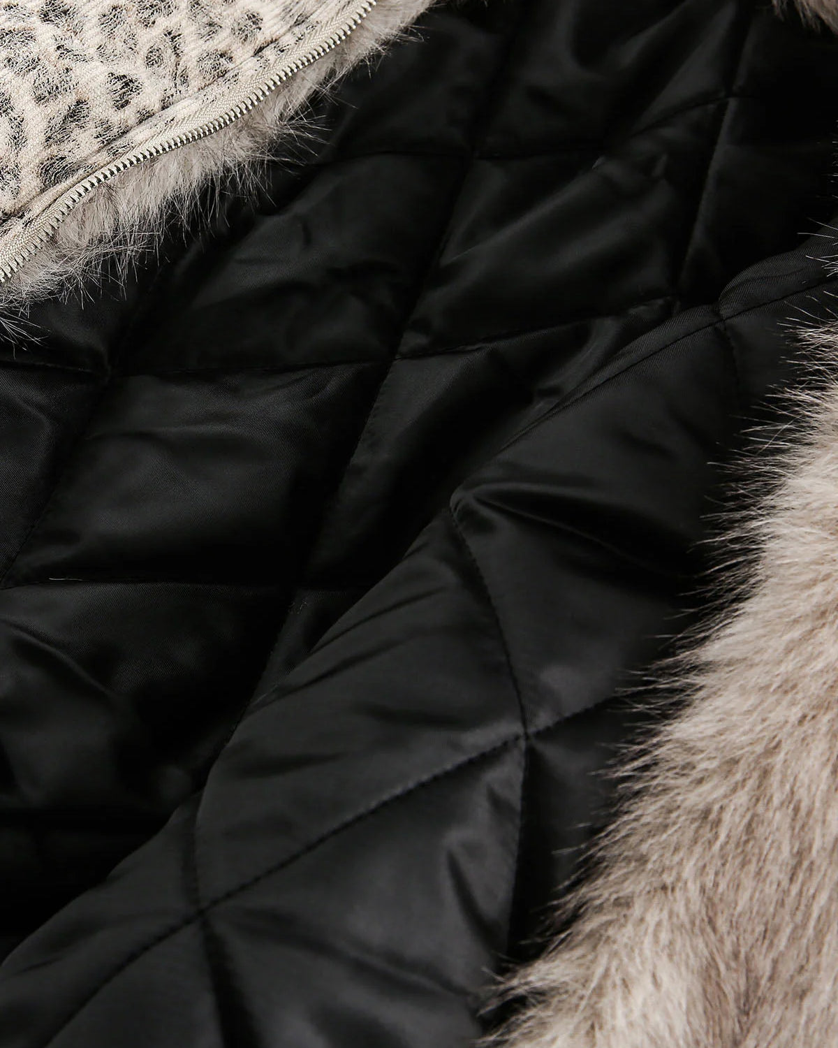Leopard Faux Fur Hooded Jacket's interior, showcasing quilted lining, light faux fur trim, leopard-print collar panel, and a metal zipper for warmth and bold style.