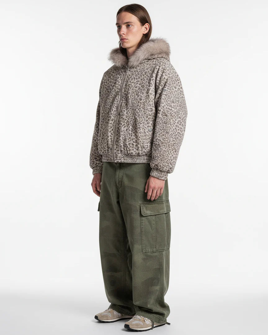 Model wearing Leopard Faux Fur Hooded Jacket with fluffy trim, paired with olive cargo pants and beige-grey sneakers, showcasing a stylish winter streetwear look.