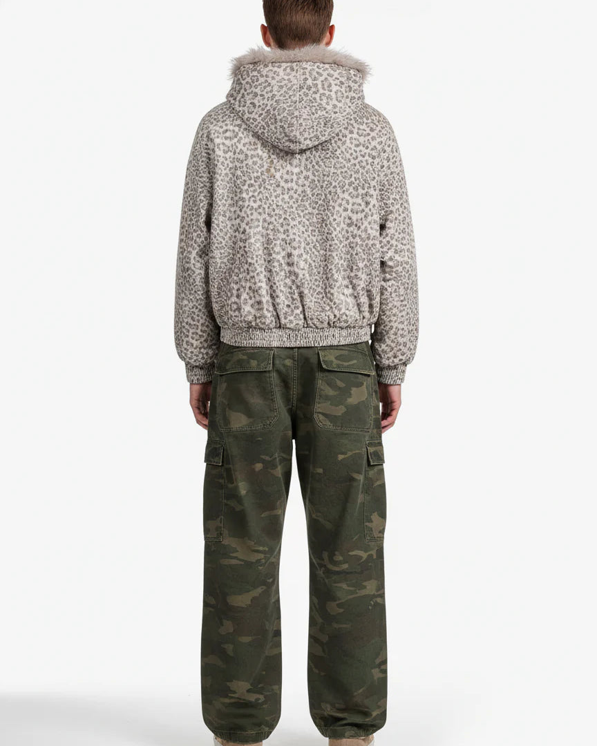 Person wearing Leopard Faux Fur Hooded Jacket with fur-trimmed hood, paired with camouflage cargo pants and low-top sneakers, showcasing a stylish winter streetwear look.
