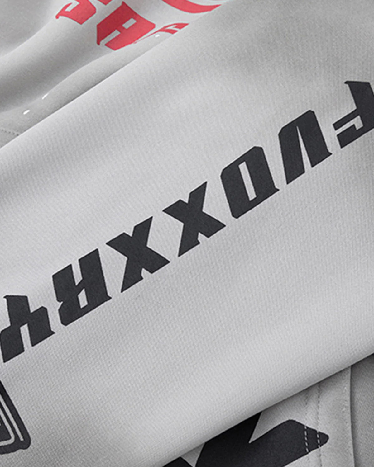 Racing Graphic Distressed Streetwear Hoodie featuring bold black and red block text on off-white fabric, showcasing oversized vintage racing-inspired graphics and distressed wash.