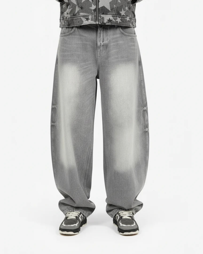 Retro Washed Grey Baggy Jeans with a wide curved-leg silhouette, faded effect on thighs and knees, styled with black-and-white sneakers for a vintage streetwear look.