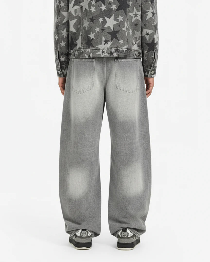 Back view of person wearing Retro Washed Grey Baggy Jeans, showcasing their wide, curved-leg silhouette and faded effect, paired with casual sneakers.