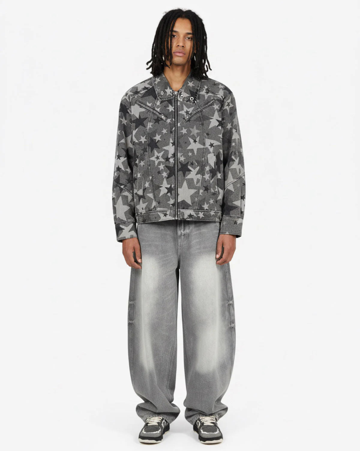 Model in Retro Washed Grey Baggy Jeans with star print denim jacket, showcasing wide, faded silhouette and chunky sneakers, embodying vintage streetwear style.