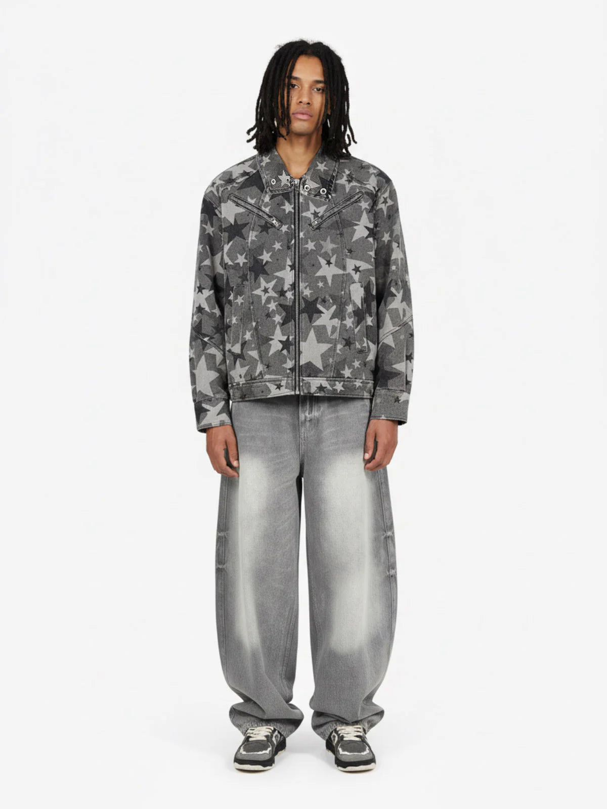 Model in Retro Washed Grey Baggy Jeans with star print denim jacket, showcasing wide, faded silhouette and chunky sneakers, embodying vintage streetwear style.