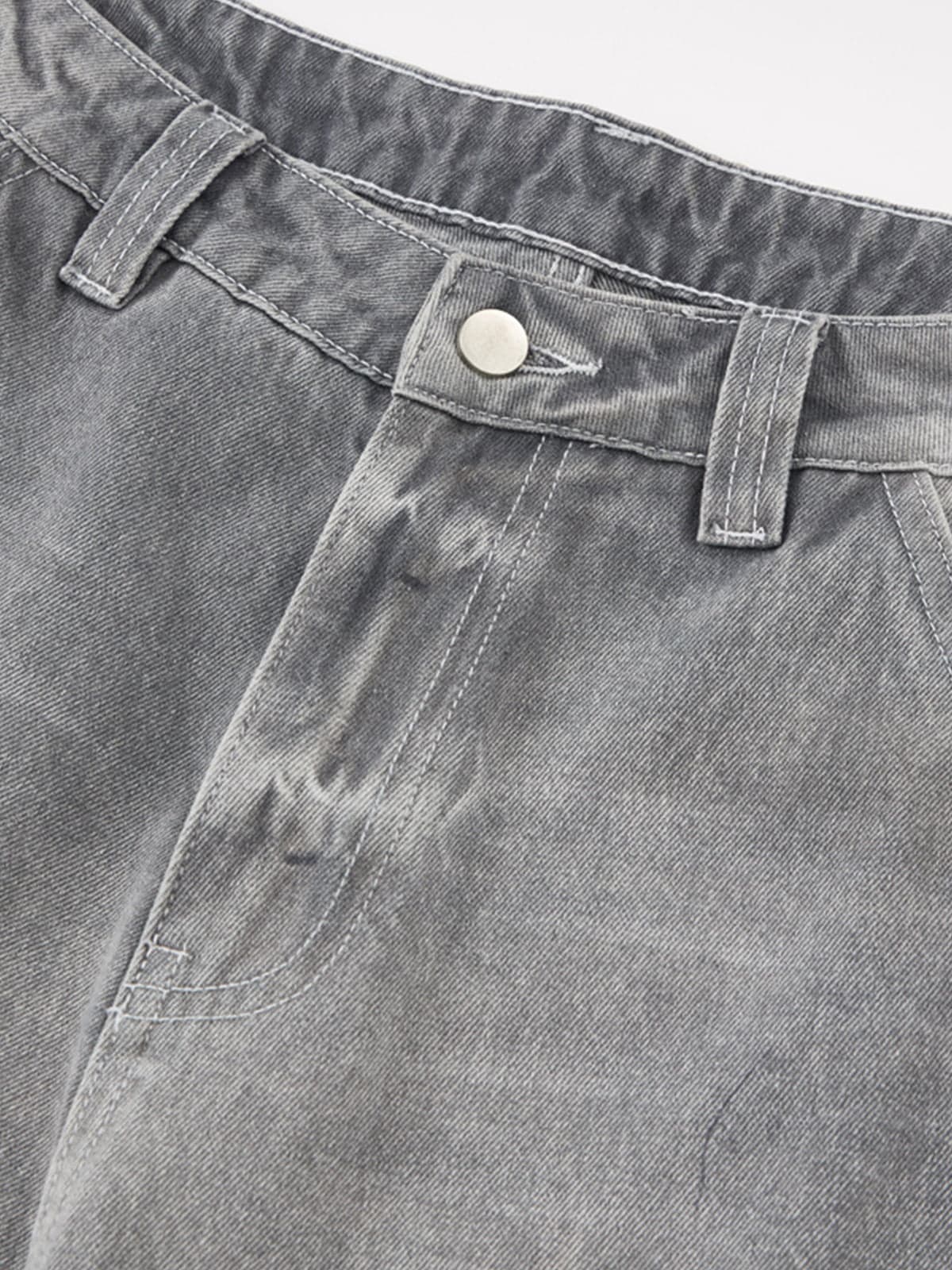 Close-up of Retro Washed Grey Baggy Jeans showing waistband details with belt loops, button closure, and pocket stitching, highlighting vintage-inspired streetwear style.
