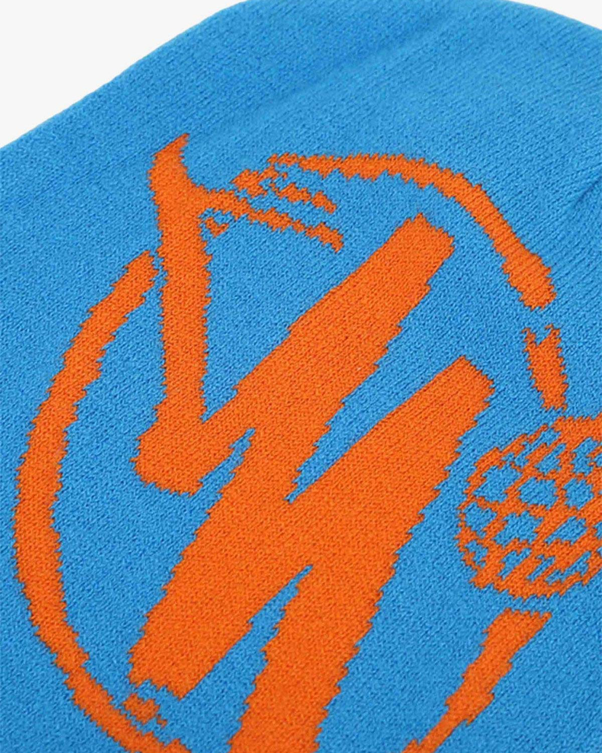 Streetwear Knit Hat featuring a bold orange stylized M graphic on bright blue knit, perfect for adding a bold touch to urban fashion.