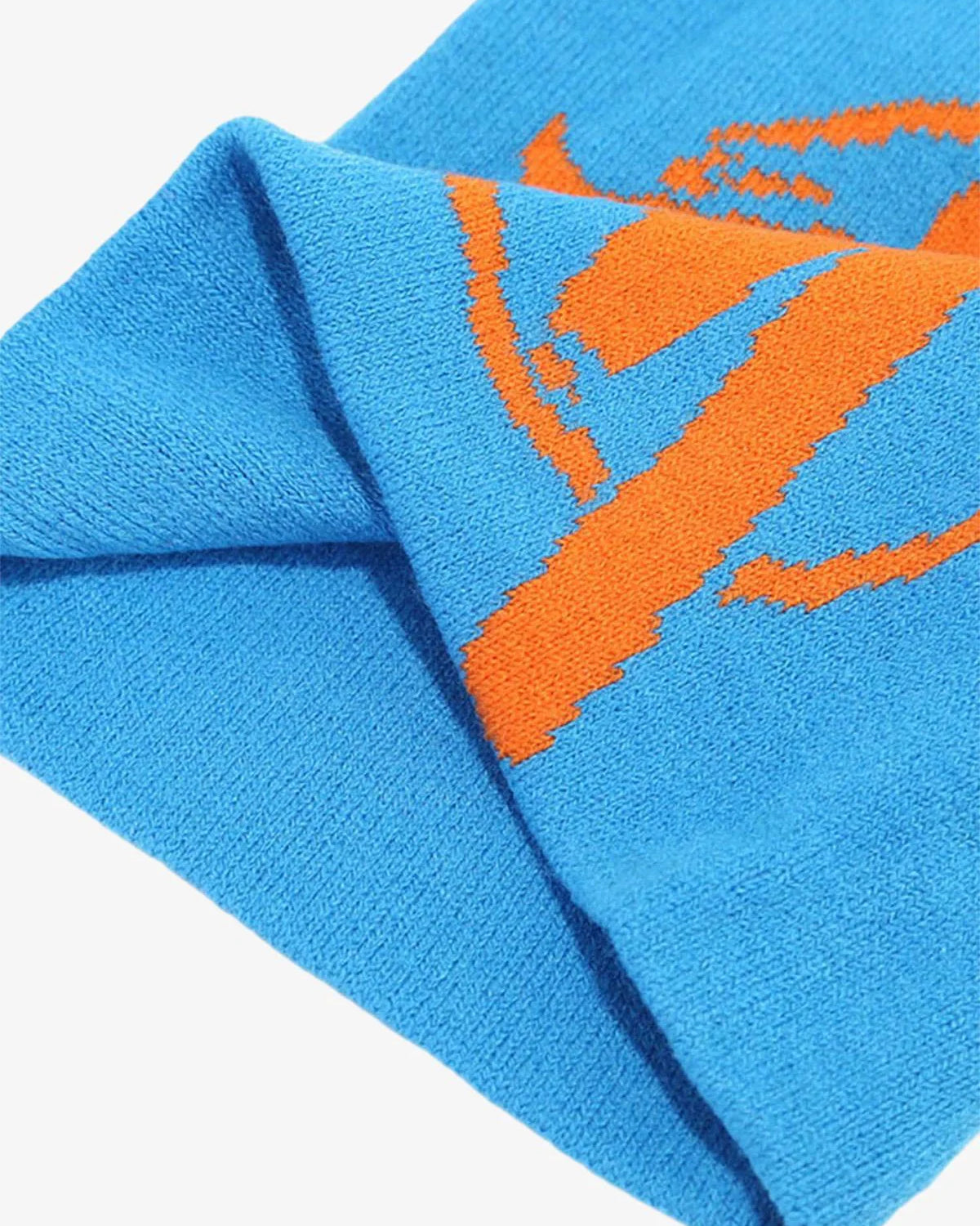 Streetwear Knit Hat: Close-up of a bright blue knitted beanie with an integrated orange stylized basketball graphic, showcasing bold streetwear aesthetics and a relaxed silhouette.