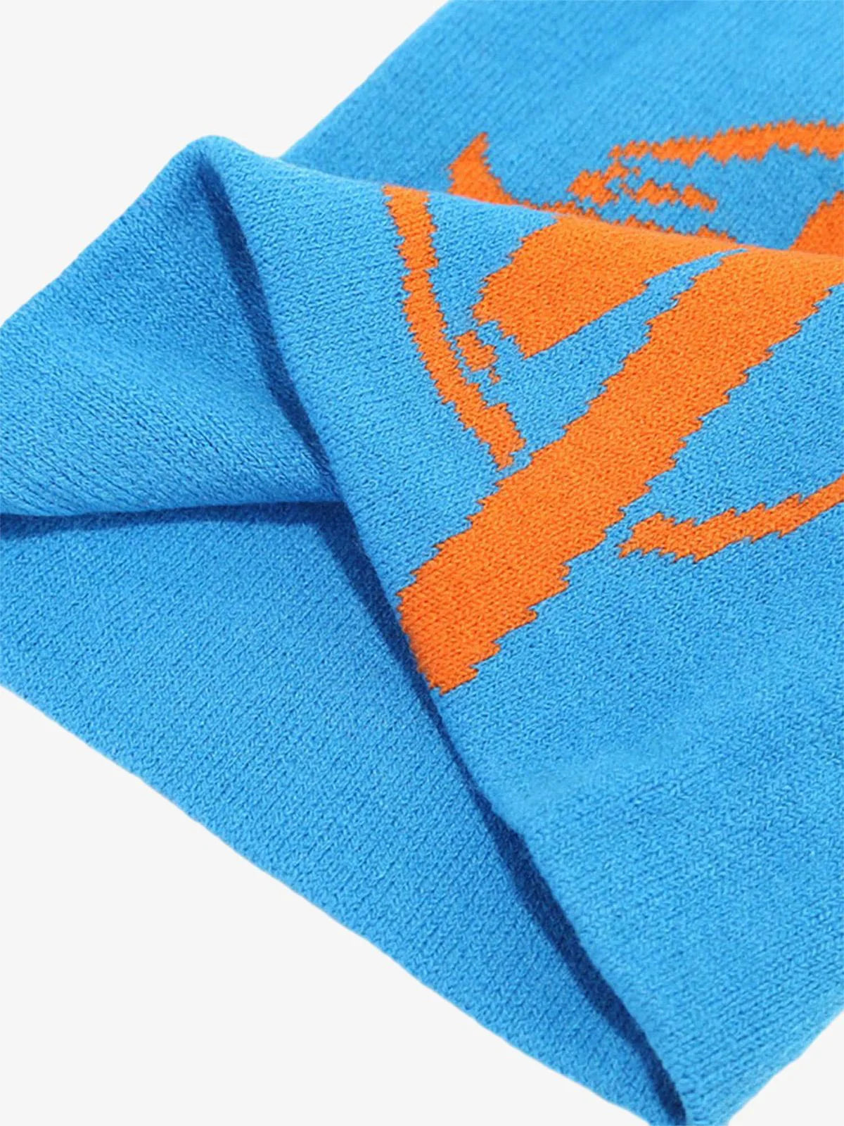 Streetwear Knit Hat: Close-up of a bright blue knitted beanie with an integrated orange stylized basketball graphic, showcasing bold streetwear aesthetics and a relaxed silhouette.