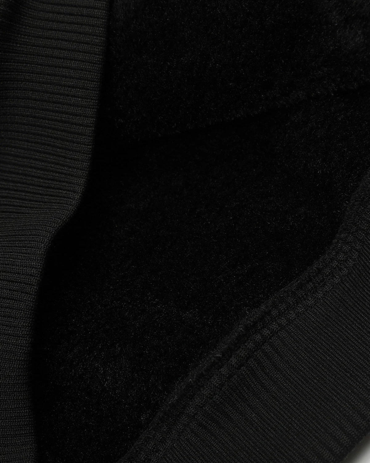 Close-up of the Vintage Hooded Leather-Look Street Jacket, showcasing a ribbed edge and cozy fleece lining for warmth and retro streetwear style.