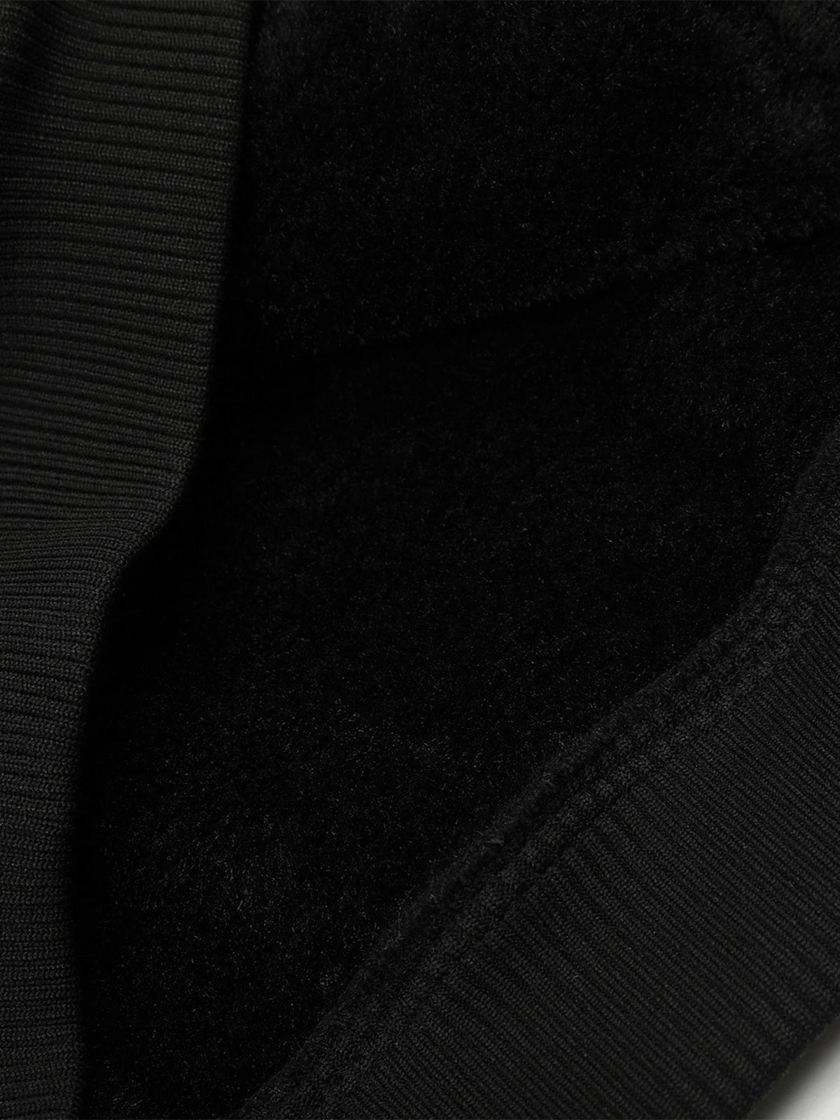 Close-up of the Vintage Hooded Leather-Look Street Jacket, showcasing a ribbed edge and cozy fleece lining for warmth and retro streetwear style.