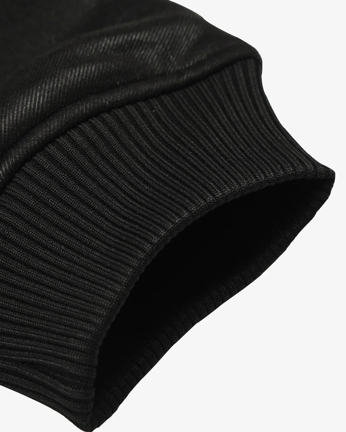 Close-up of a black, ribbed knit cuff on the Vintage Hooded Leather-Look Street Jacket, highlighting its retro streetwear style and warm fleece interior.