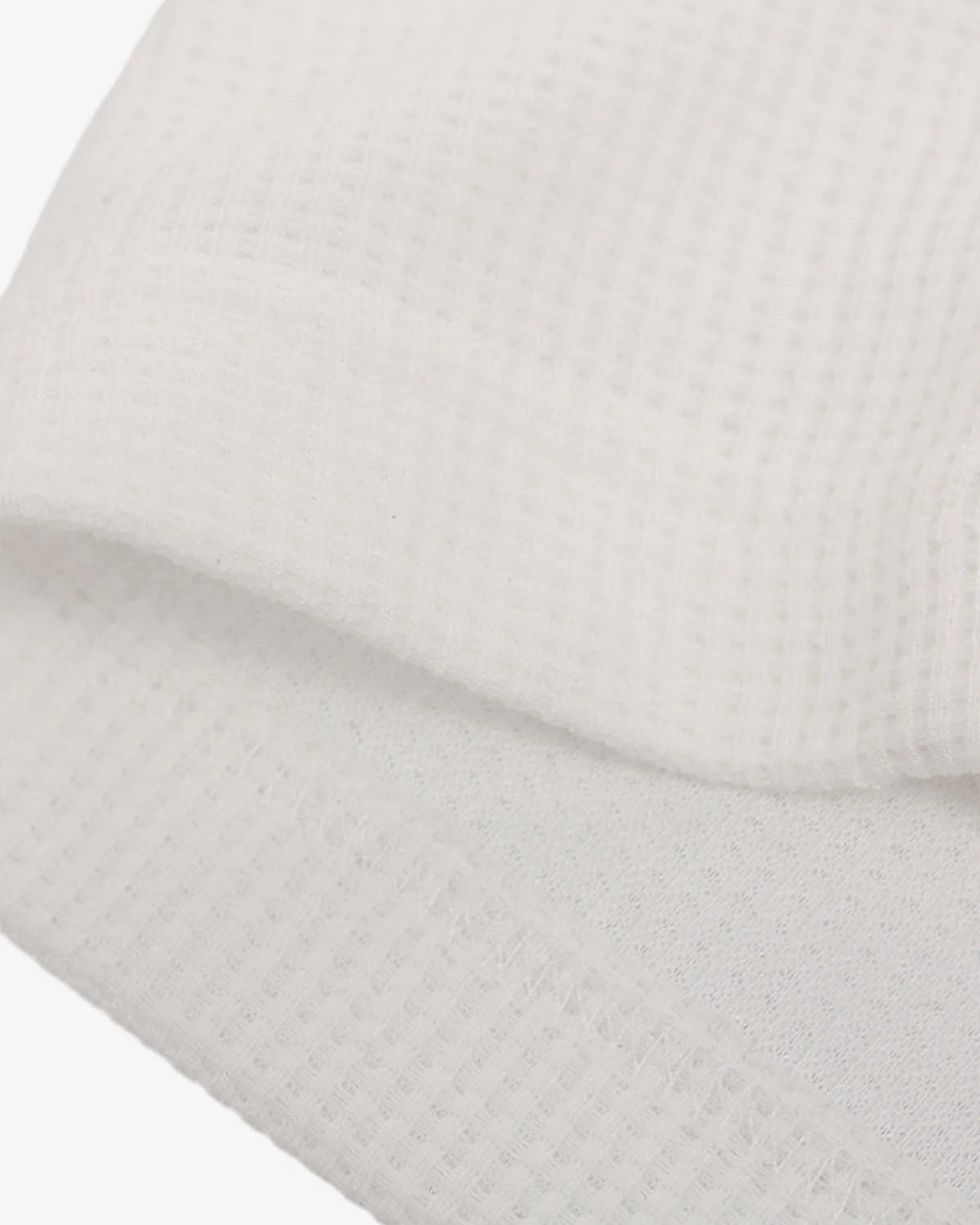 Close-up of Vintage Waffle Graphic Long-Sleeve T-Shirt, highlighting waffle-weave texture and stitched edge, embodying retro streetwear aesthetic with relaxed fit and vintage graphics.