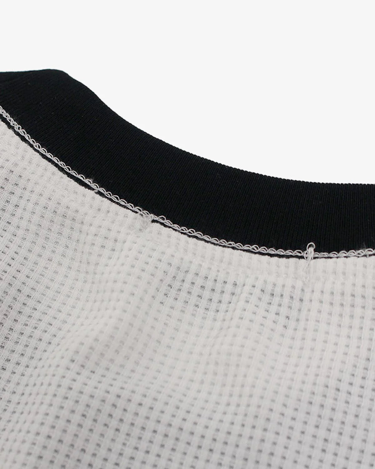 Close-up of the Vintage Waffle Graphic Long-Sleeve T-Shirt's neckline, featuring a waffle-knit texture and black rib-knit collar with visible overlock stitching.