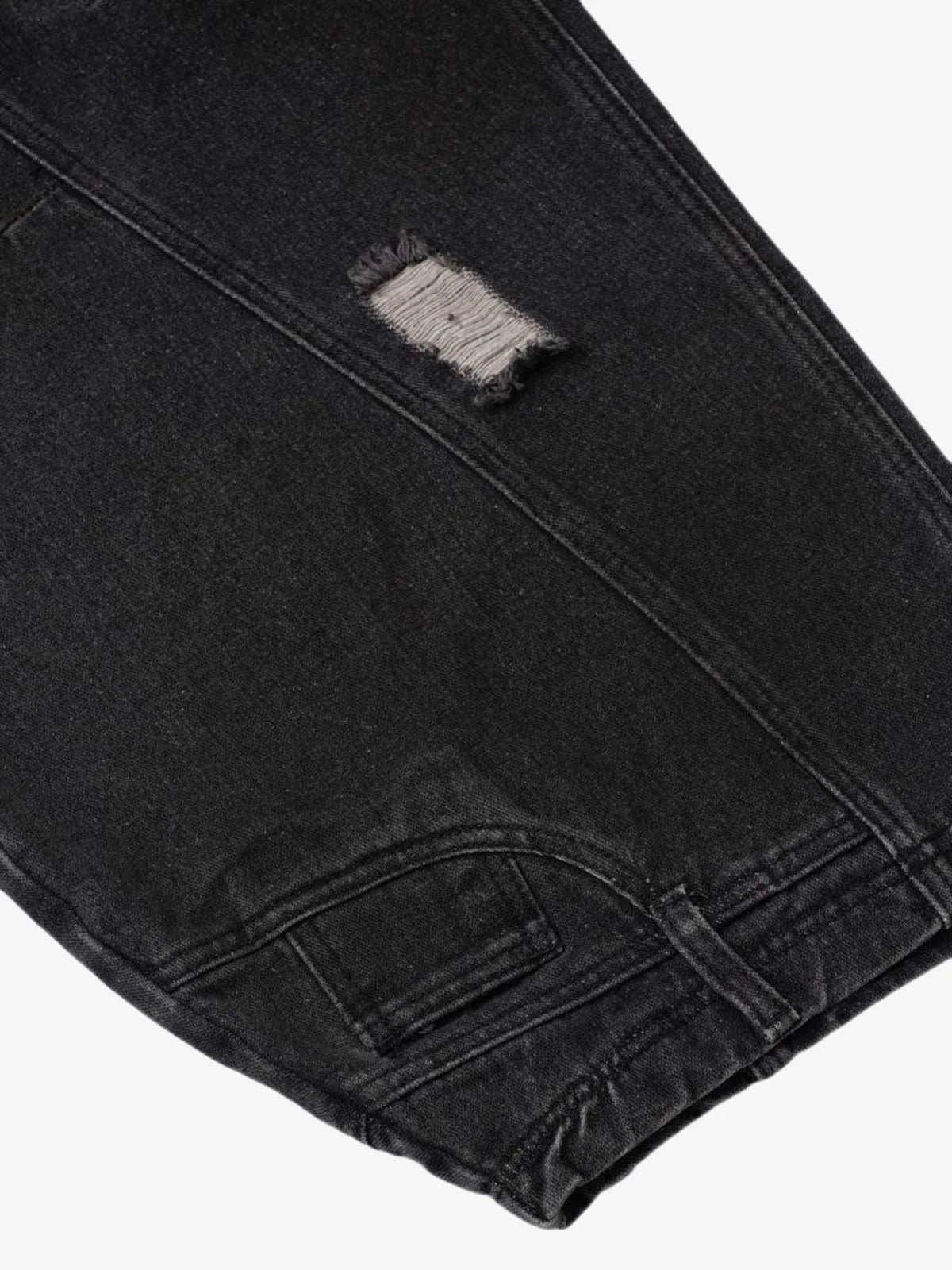 Close-up of Vintage Washed Baggy Ripped Jeans showcasing a distressed patch above the knee, emphasizing the oversized, relaxed streetwear silhouette.