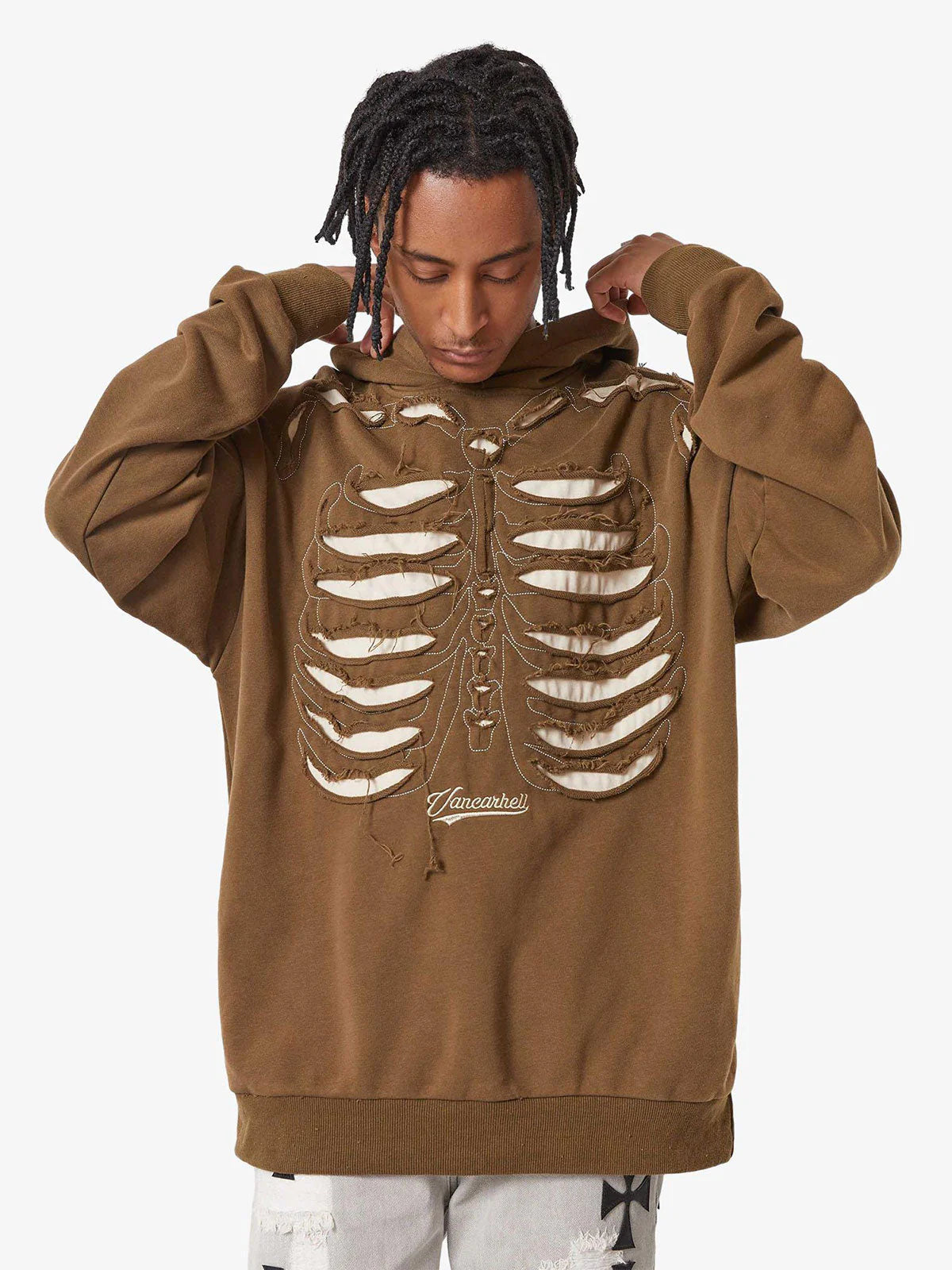Model in a Washed Skeleton Graphic Streetwear Hoodie, featuring a rib-cage motif with cut-outs, adjusting hood; embodies vintage streetwear with oversized fit.