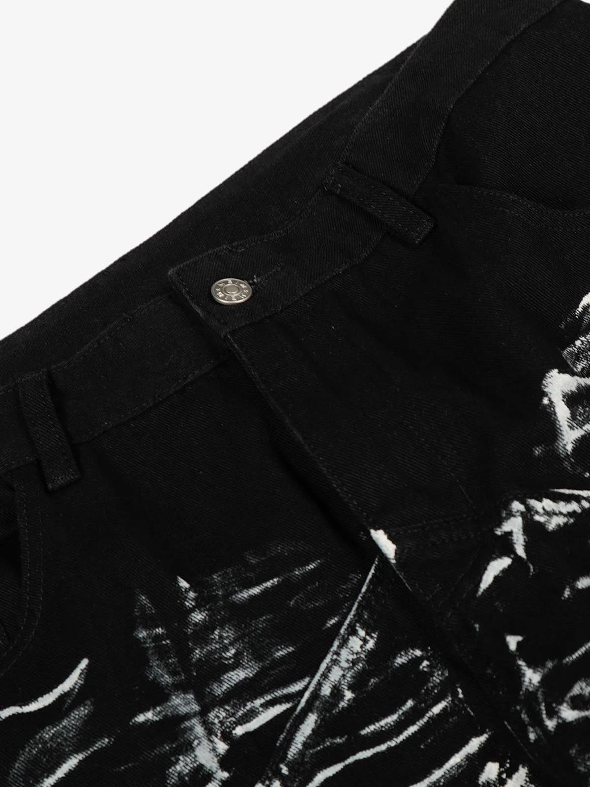 Black Star Paint Baggy Jeans close-up showing waistband, belt loops, and metal button, featuring white paint-splatter pattern and star graphics on black denim for a bold street style.