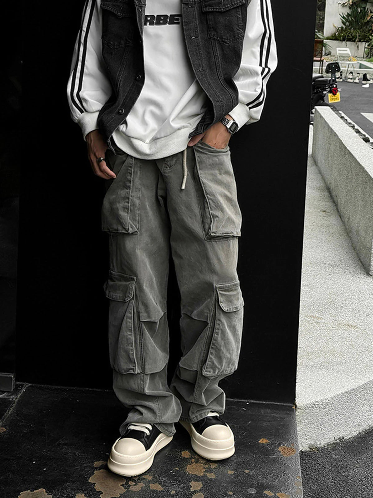 Chunky Low-Top Streetwear Sneakers with thick platform soles, black uppers, and off-white toe caps, styled with cargo pants for a modern urban look.