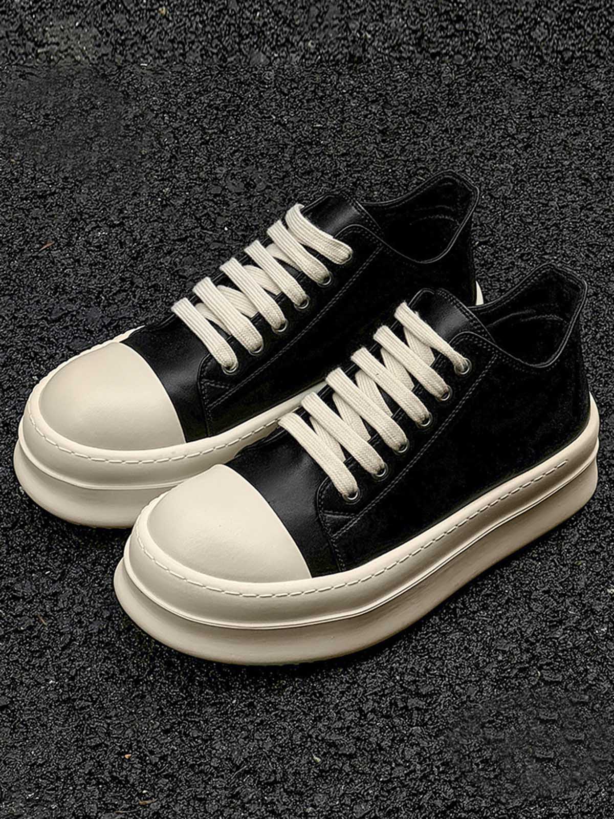 Chunky Low-Top Streetwear Sneakers with smooth black upper, off-white rubberized toe cap, and thick platform sole, offering bold style and modern streetwear appeal.