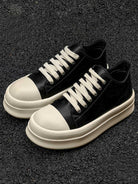 Chunky Low-Top Streetwear Sneakers with smooth black upper, off-white rubberized toe cap, and thick platform sole, offering bold style and modern streetwear appeal.