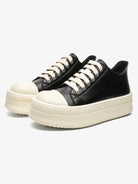Chunky Low-Top Streetwear Sneakers with black uppers, off-white toe caps and thick soles, offering a bold, German-trainer inspired silhouette for modern streetwear.