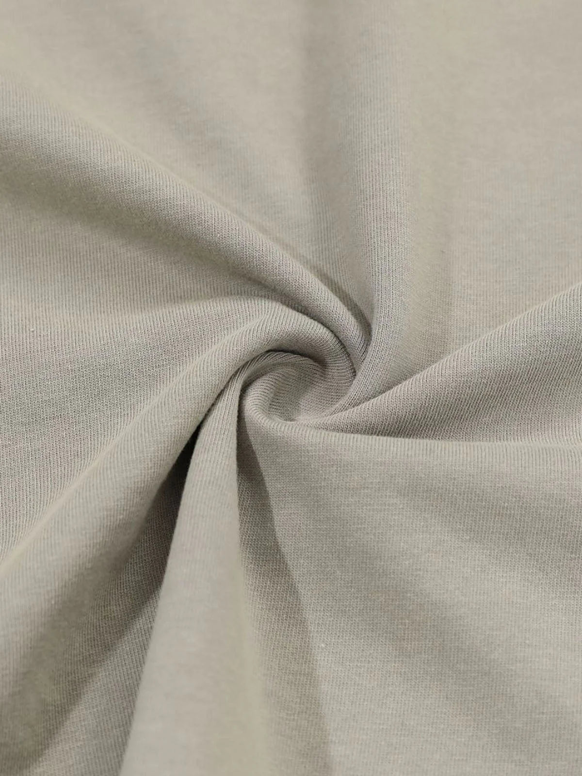 Distressed Grunge Layered T-Shirt featuring a close-up of beige knit fabric texture, showcasing its gathered texture, highlighting the layered camo sleeves and vintage graphic style.